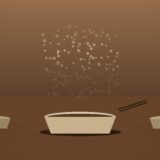 湯気の立つお椀と二つの皿、温かい食卓のシーン